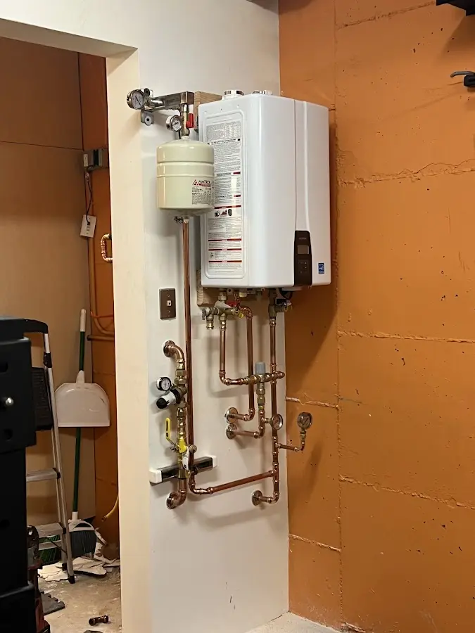 Plumbing technician inspecting water heater connections in Diamondhead